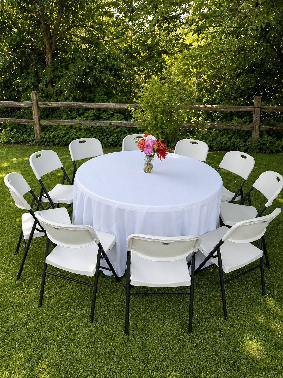 Round table with white linen and white folding chairs — a real Mateo Party Co. setup.