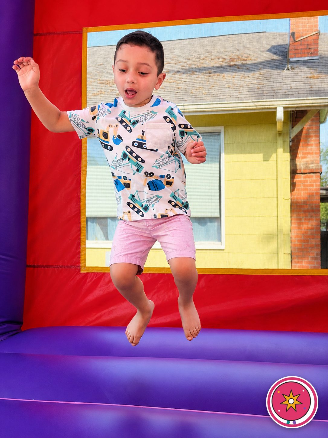 A boy mid-jump having fun in a Mateo Party Co. bounce house