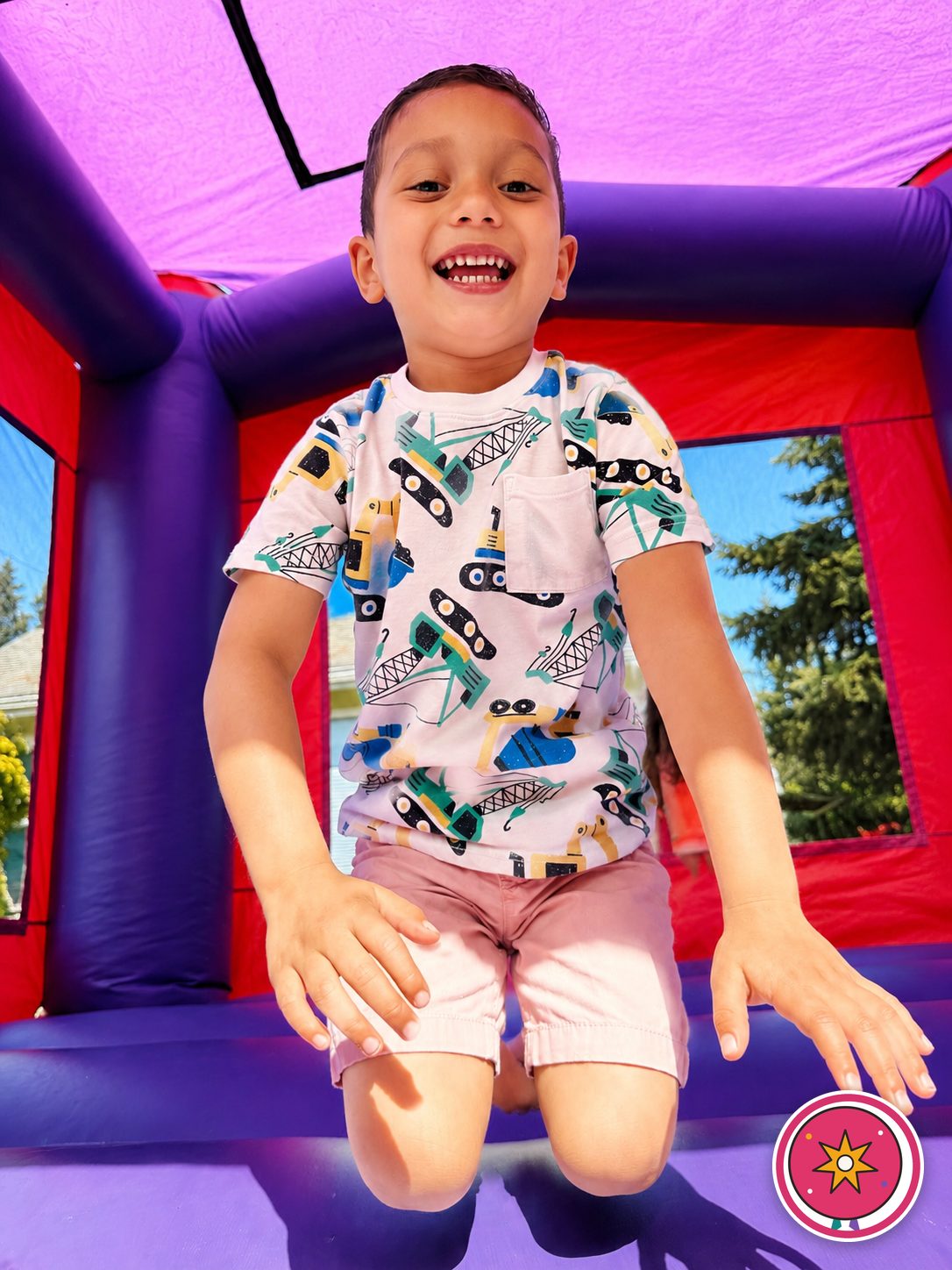 A smiling child jumping in a Mateo Party Co. bounce house